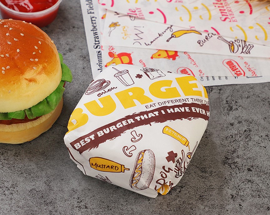 กระดาษเคลือบกันไขมัน (grease-proof paper) พิมพ์ลาย สำหรับห่อแฮมเบอร์เกอร์ (แพ็ค 100 แผ่น)